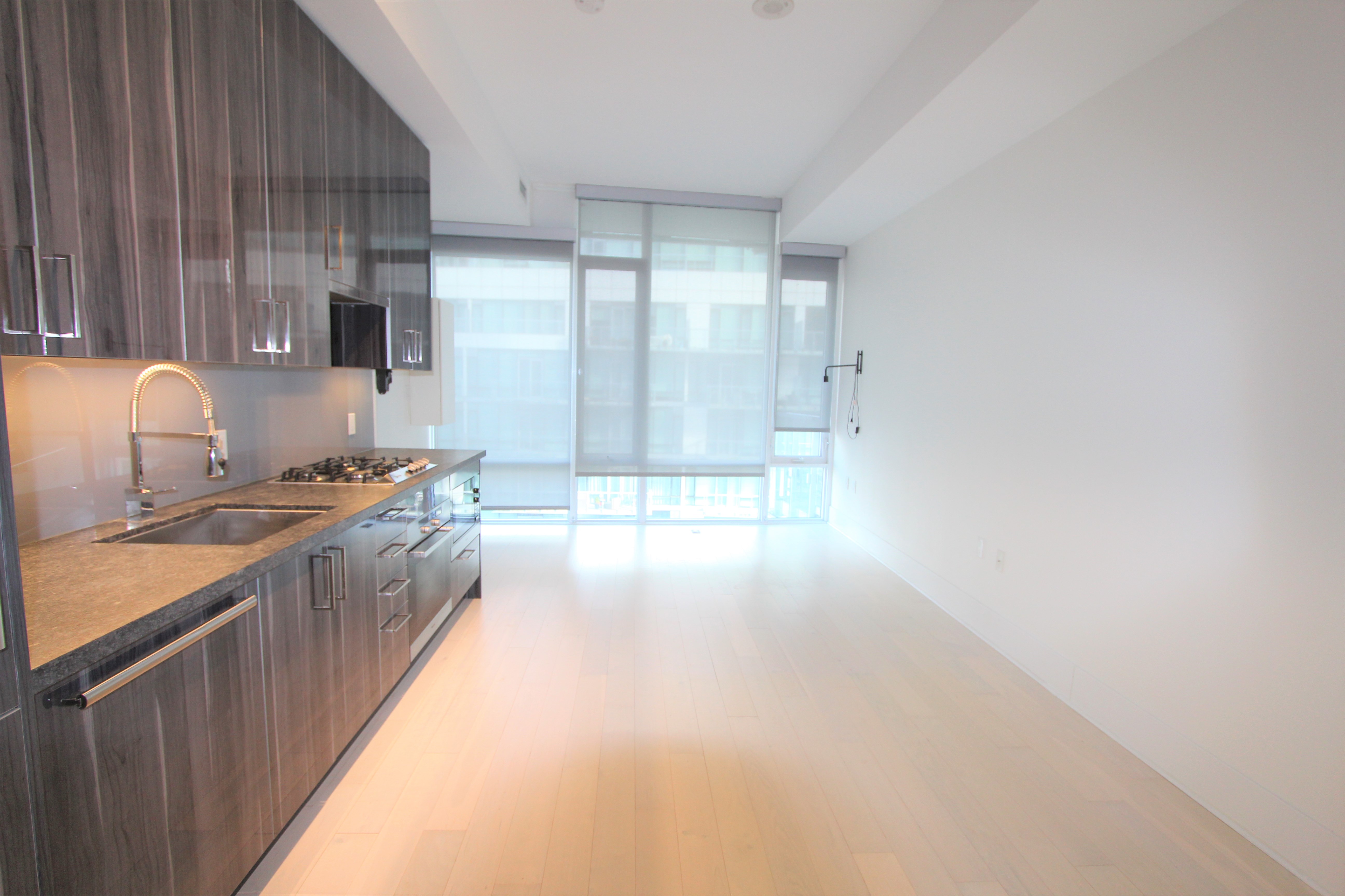 Open-concept living area with 10 ft ceilings and hardwood floors