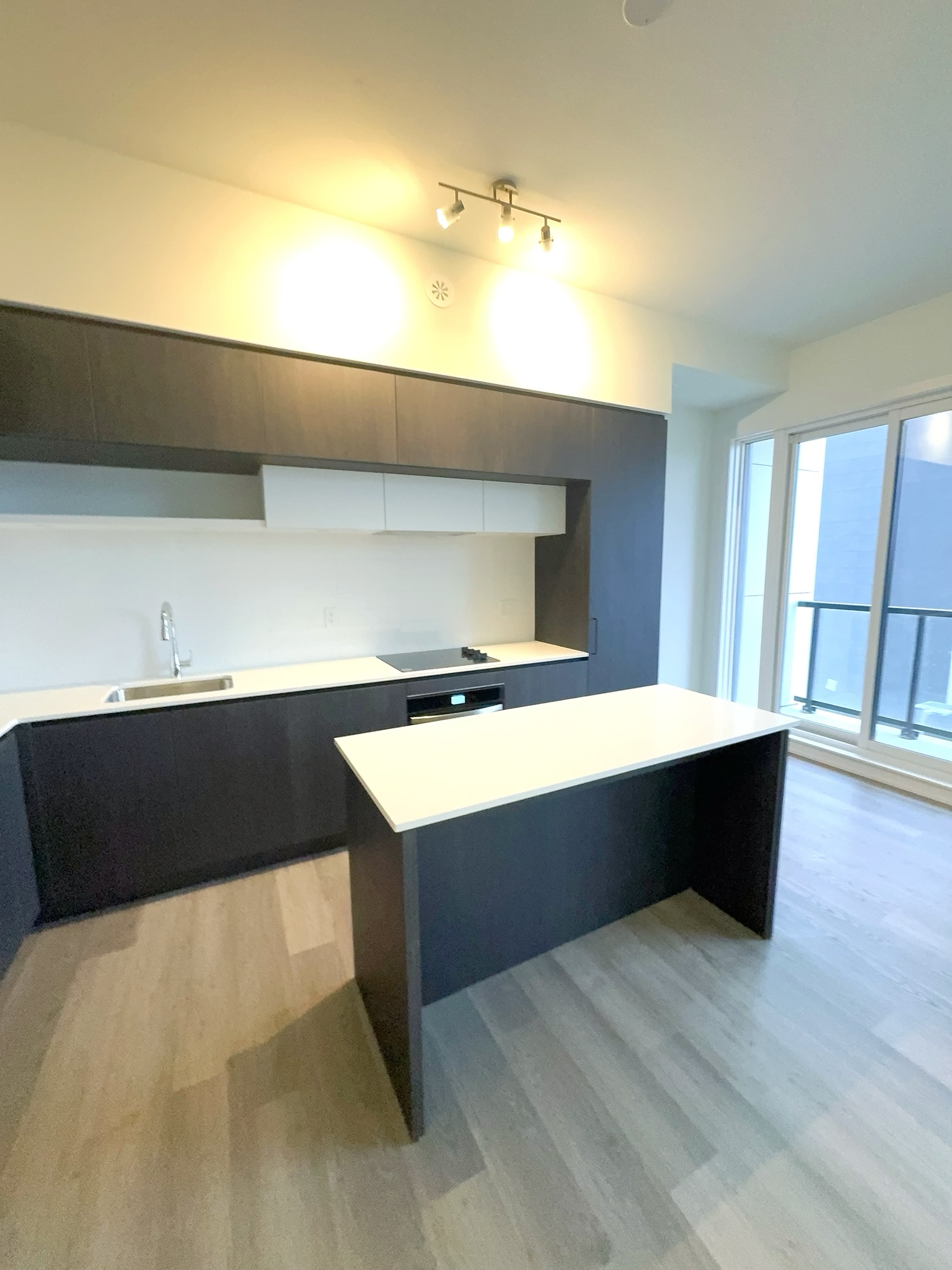 Modern kitchen with quartz counters, island and stainless appliances