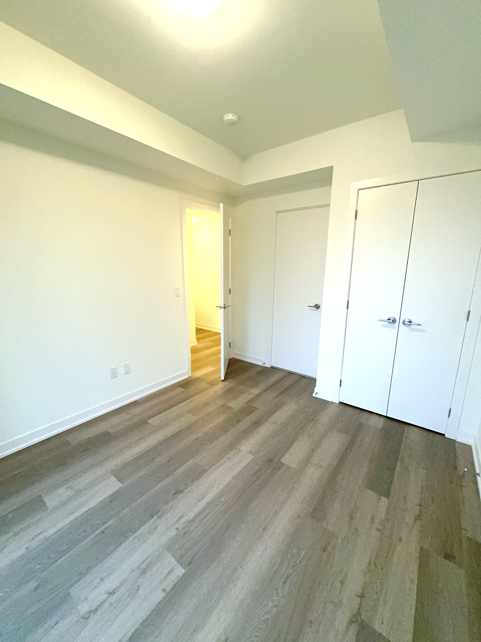 Second bedroom with large window and closet