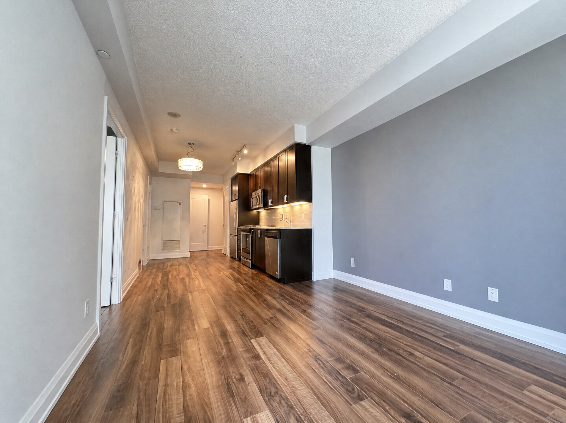 Living area with floor-to-ceiling windows and balcony walk-out