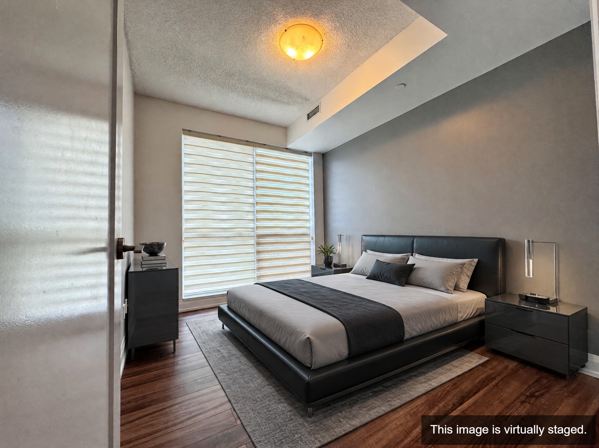 Virtually staged — open-concept living and dining with SW ravine views