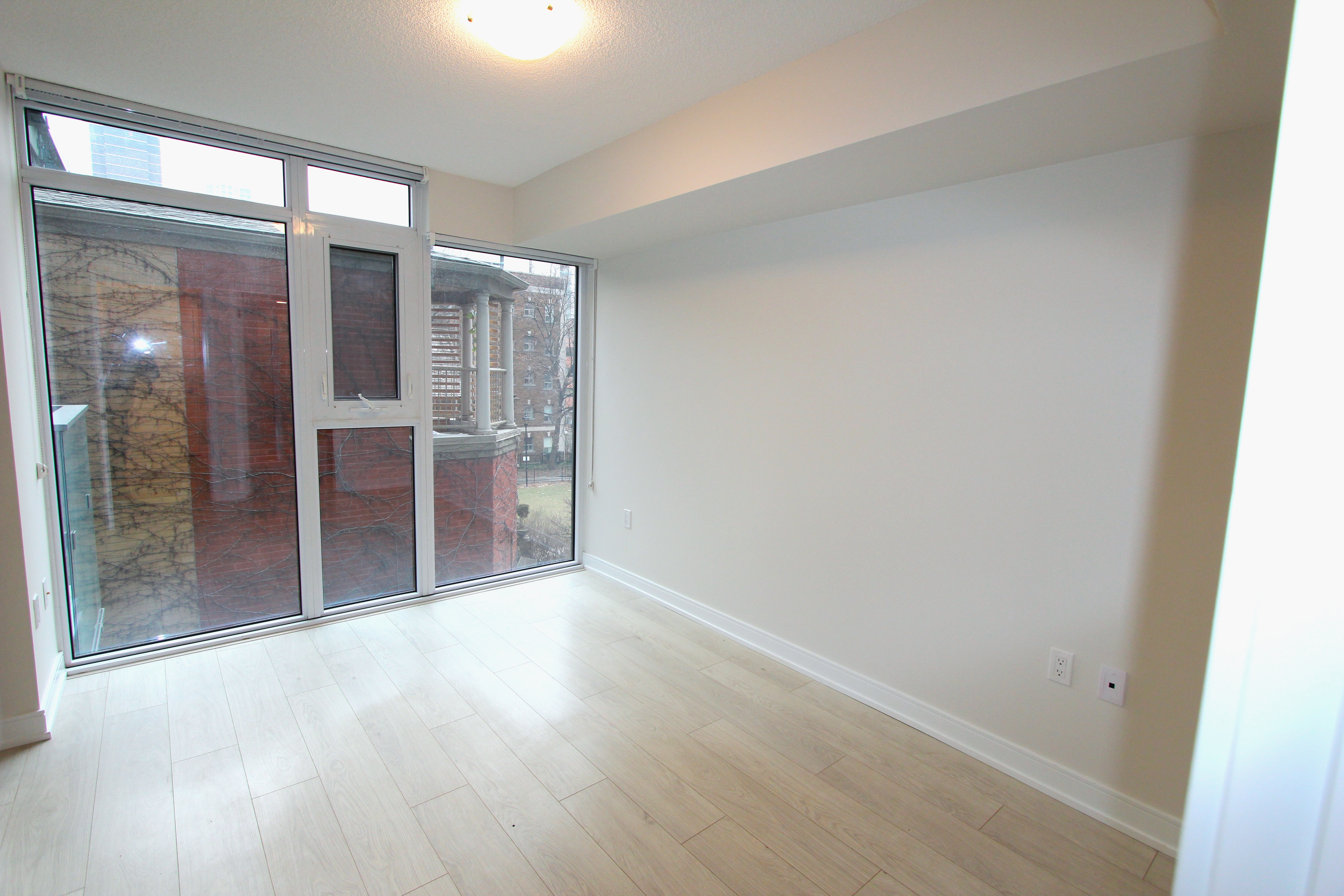 Open-concept living and dining with NE corner windows and balcony walkout