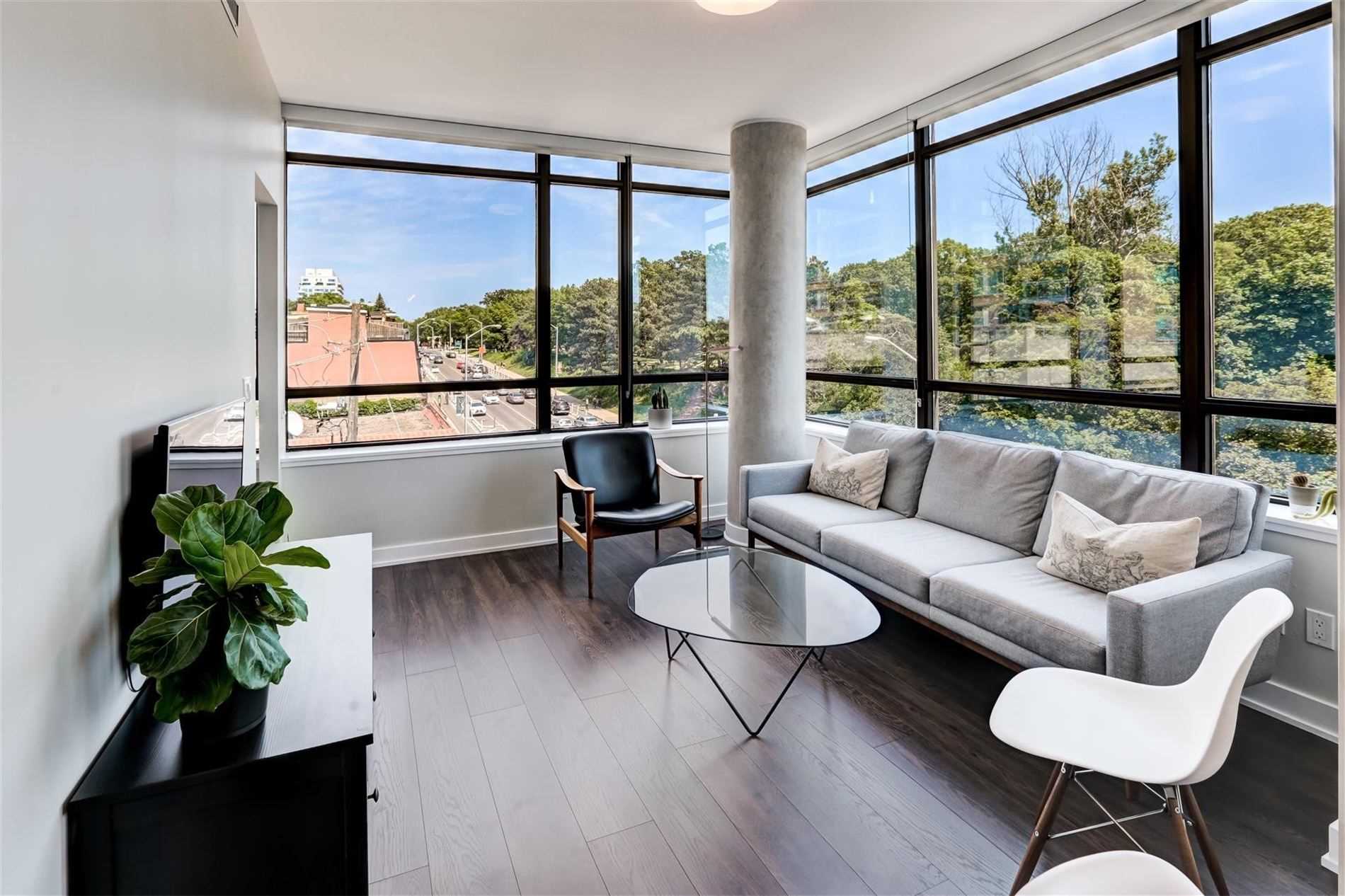 Living area with laminate flooring and large windows