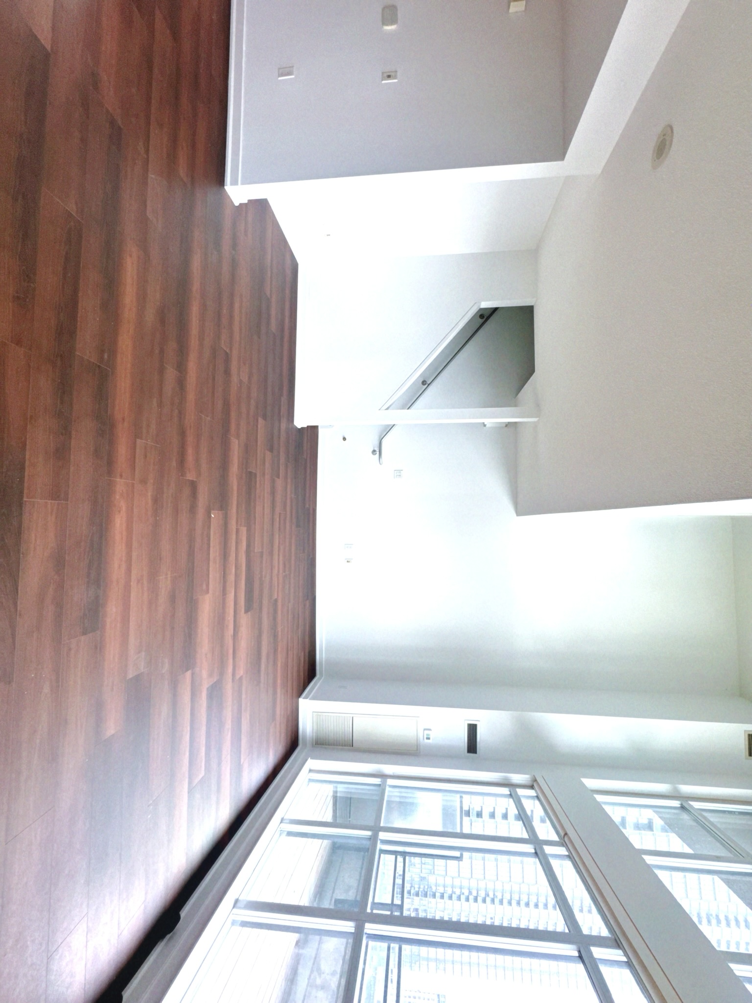 Loft bedroom level with floor-to-ceiling windows