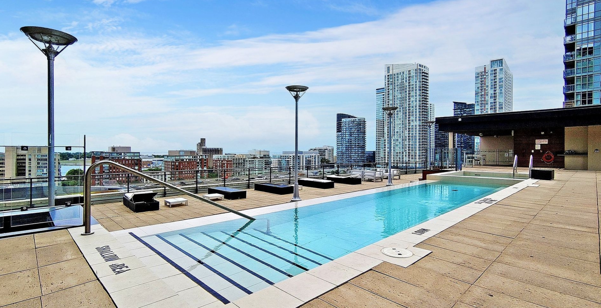 Outdoor rooftop pool with panoramic city and lake views