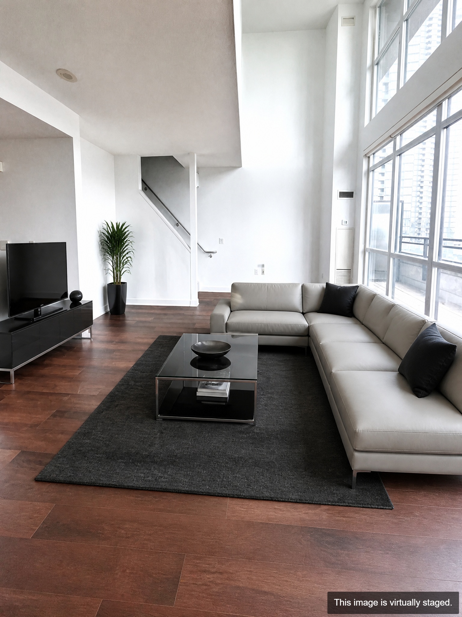 Virtually staged — open-concept living room with 9 ft ceilings and floor-to-ceiling windows